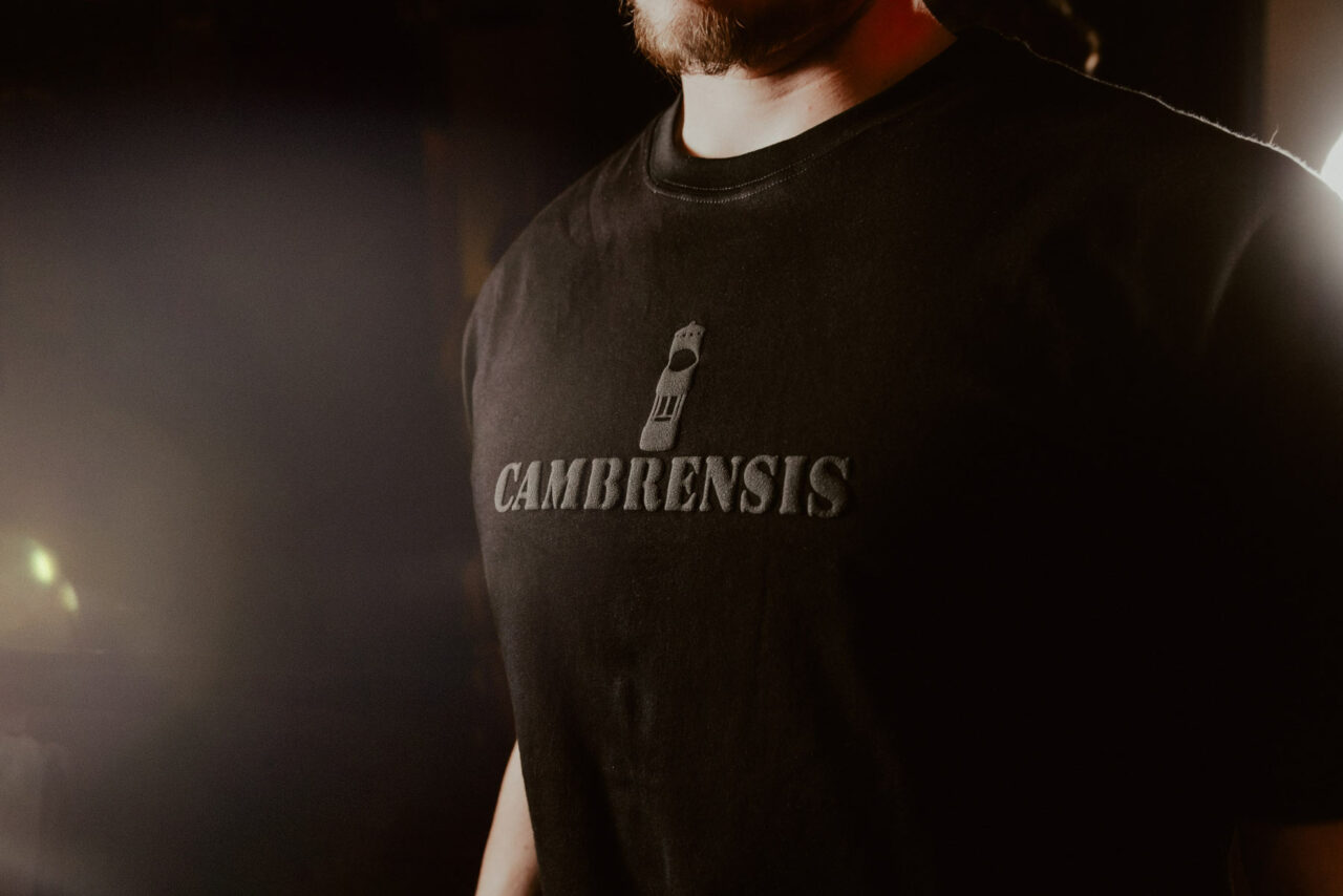Close up of model wearing a black Cambrensis t-shirt. Shot for Cambrensis menswear 'Merthyr' fashion line launch, Cardiff 2024.