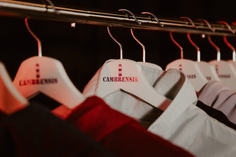 Close up of coat hanger with Cambrensis logo printed onto it. Shot for Cambrensis menswear 'Merthyr' fashion line launch, Cardiff 2024.