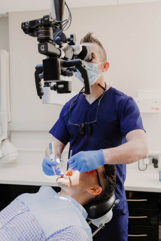 Dai the dentist performing root canal dentistry at Greenfield Dental Care. Shot on location for WCS agency, Cardiff.