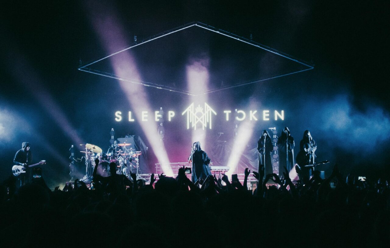 Wide shot of Sleep Token frontman Vessel singing on stage. Shot on the This Place Will Become Your Tomb tour with Architects.